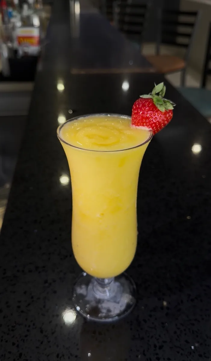 Frozen tropical cocktail with strawberry garnish